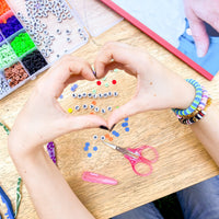 Friendship bracelet-making kit with colorful beads and string