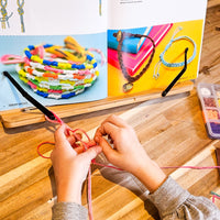 Friendship bracelet-making kit with colorful beads and string