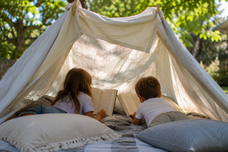 summer reading outside in a blanket fort